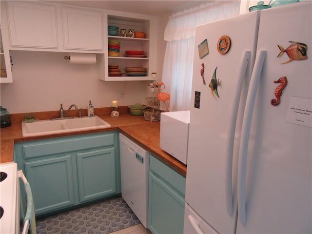 kitchen with wooden counters, sink, white appliances, and light tile patterned flooring