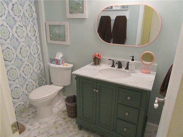 bathroom featuring tile patterned floors, toilet, and vanity