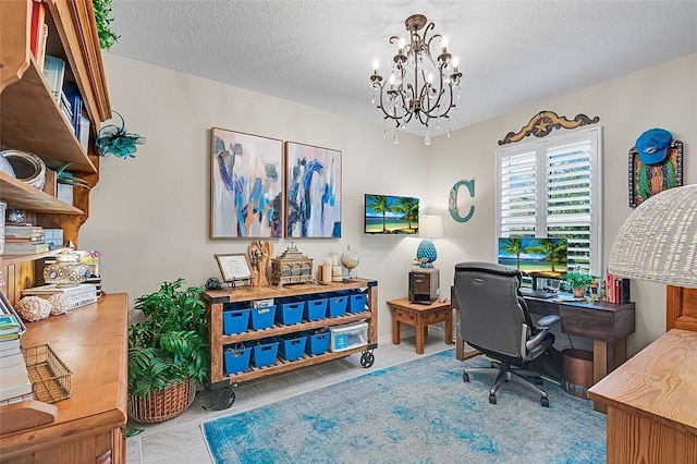 office area with a textured ceiling and an inviting chandelier