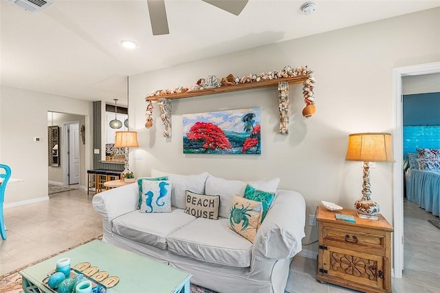 living room featuring ceiling fan, visible vents, and baseboards