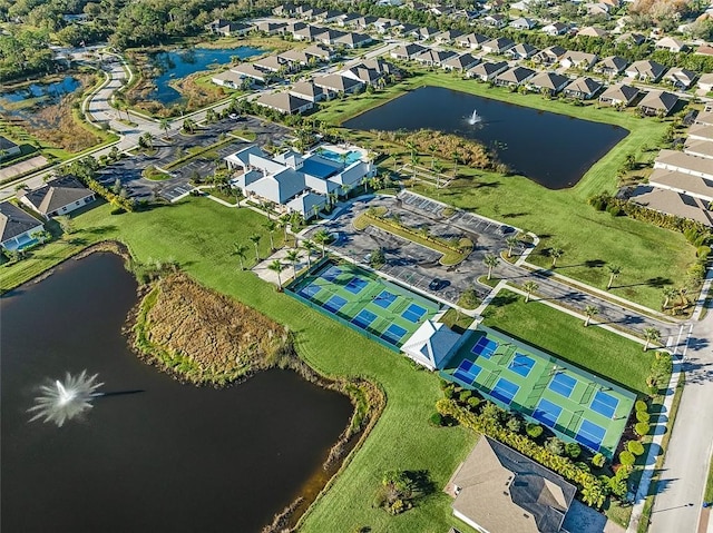 drone / aerial view featuring a residential view and a water view