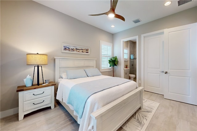 bedroom featuring ensuite bath, ceiling fan, and light hardwood / wood-style flooring