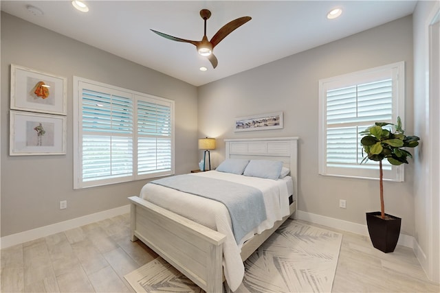 bedroom with ceiling fan and multiple windows