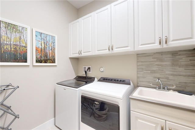 laundry area with cabinets, sink, and washer and dryer