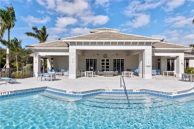 view of swimming pool featuring ceiling fan and a patio area