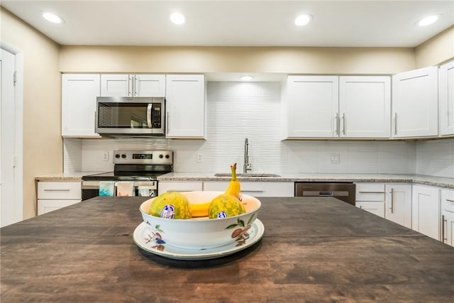 4019 Silver Palm Dr Unit 8, Vero Beach, FL 32963 - kitchen featuring tasteful backsplash, a sink, stainless steel appliances, white cabinetry, and recessed lighting