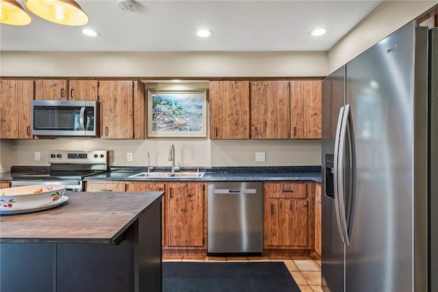 kitchen featuring light tile patterned flooring, stainless steel appliances, and sink