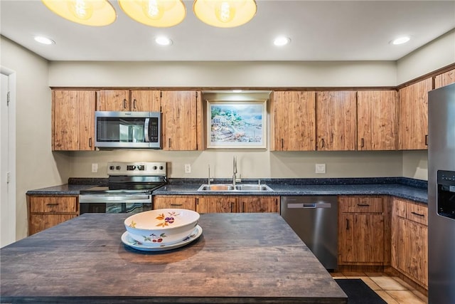 kitchen featuring appliances with stainless steel finishes, sink, and light tile patterned floors