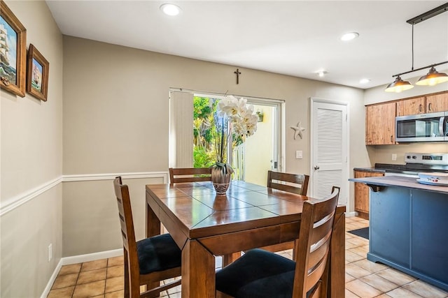 dining space featuring light tile patterned floors