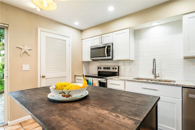 4019 Silver Palm Dr Unit 8, Vero Beach, FL 32963 - kitchen featuring backsplash, white cabinetry, stainless steel appliances, and a sink