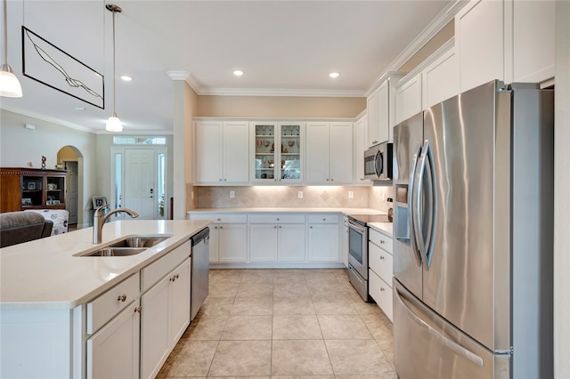 kitchen featuring appliances with stainless steel finishes, white cabinetry, hanging light fixtures, and sink