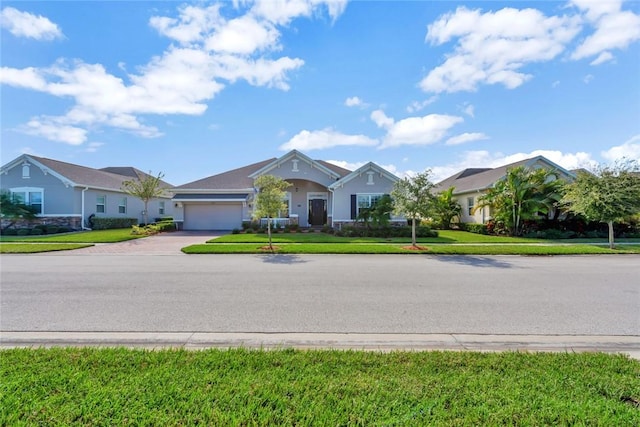 ranch-style home with a garage and a front lawn