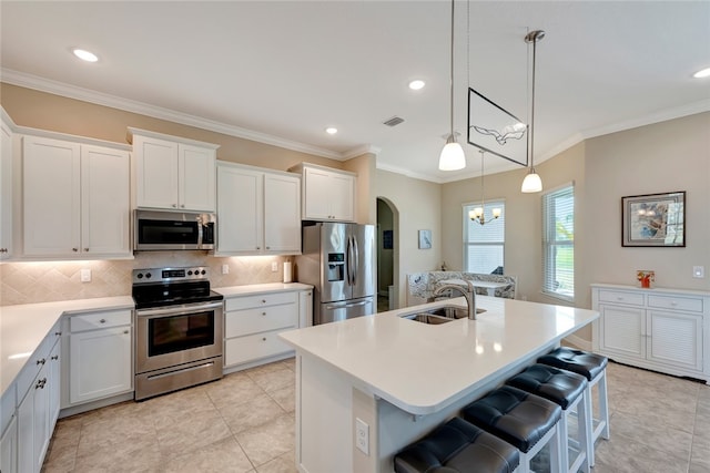 kitchen with sink, a chandelier, a center island with sink, white cabinets, and appliances with stainless steel finishes