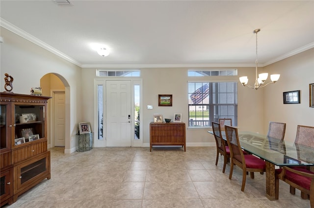 dining space with light tile patterned flooring, crown molding, and an inviting chandelier