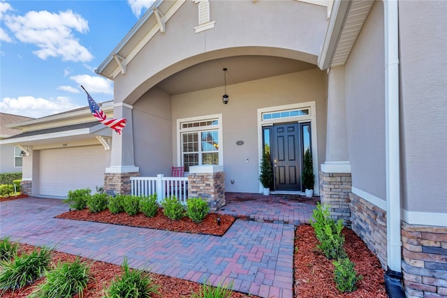 entrance to property with a garage and covered porch