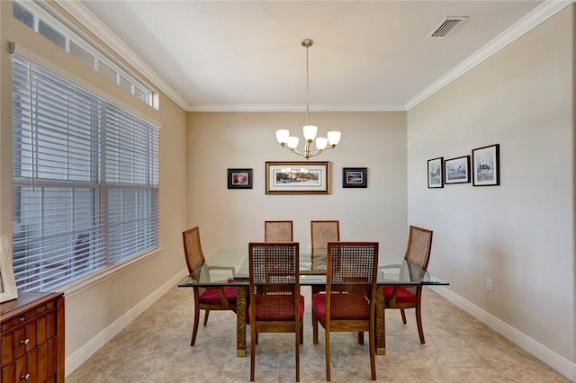 dining room with ornamental molding and an inviting chandelier