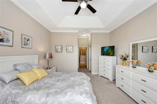 bedroom with ceiling fan, ornamental molding, light carpet, and a tray ceiling