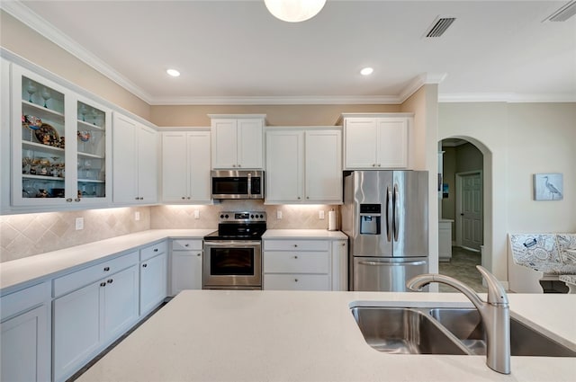 kitchen featuring sink, white cabinets, and appliances with stainless steel finishes