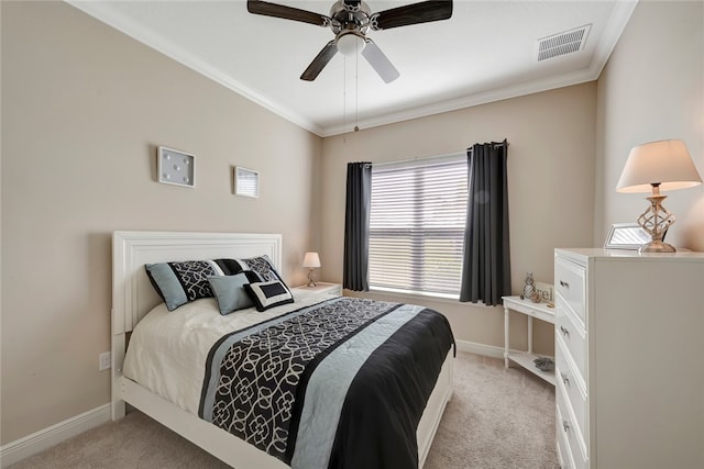 carpeted bedroom featuring ceiling fan and crown molding