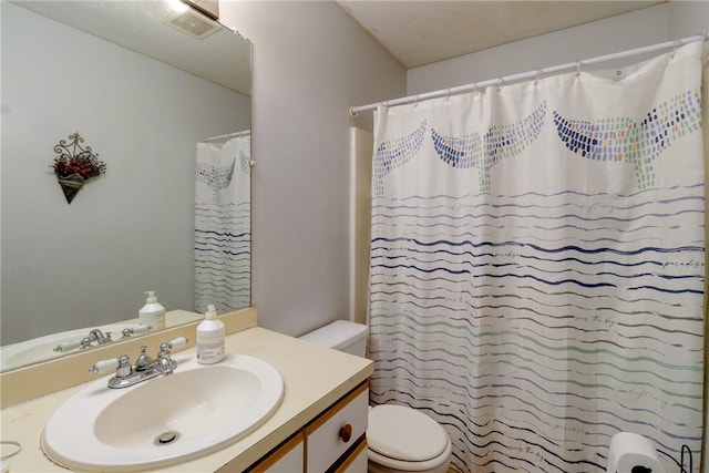 bathroom featuring vanity, curtained shower, and toilet