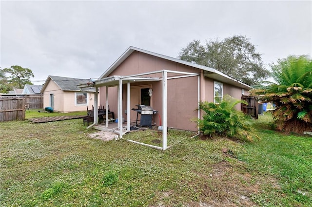 rear view of property with a lawn