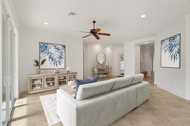 living room with light tile patterned floors, ceiling fan, and ornamental molding