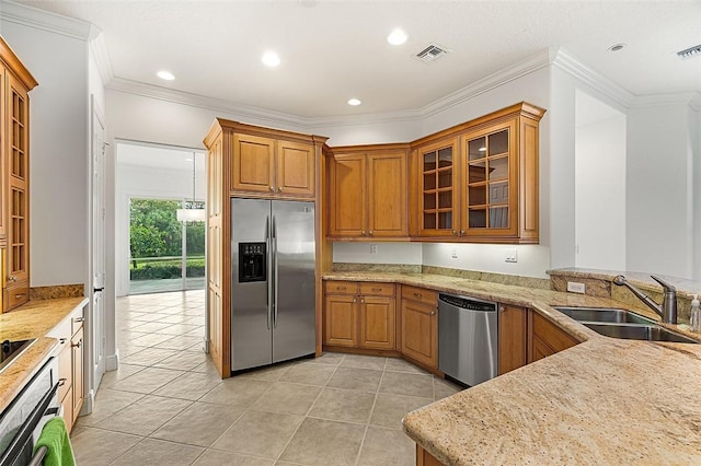kitchen with visible vents, light tile patterned flooring, a sink, stainless steel appliances, and brown cabinets