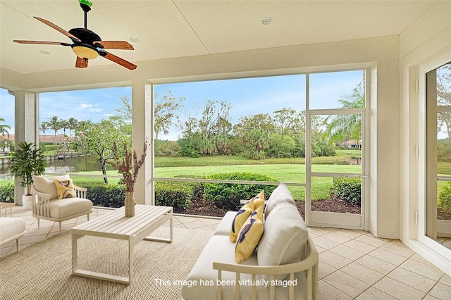 sunroom with a healthy amount of sunlight and ceiling fan