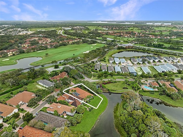drone / aerial view with a water view, golf course view, and a residential view