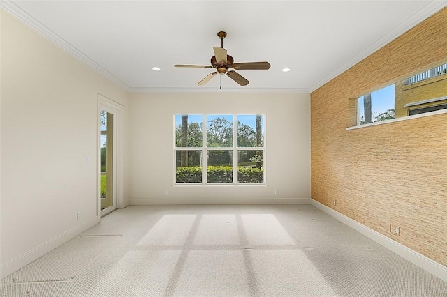 unfurnished room with ceiling fan, light colored carpet, and ornamental molding