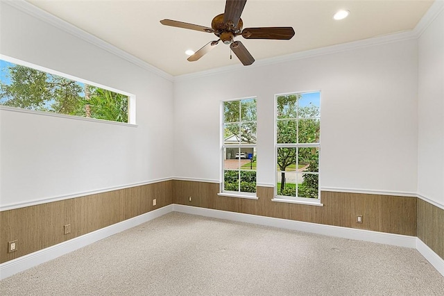 unfurnished room featuring ceiling fan, a healthy amount of sunlight, and ornamental molding