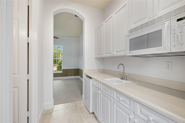 kitchen with light carpet, white cabinets, sink, and white appliances