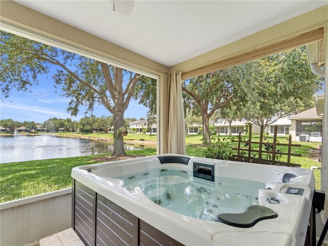 2540 12th Sq SW, Vero Beach, FL 32968 - sunroom featuring a hot tub, a water view, and plenty of natural light