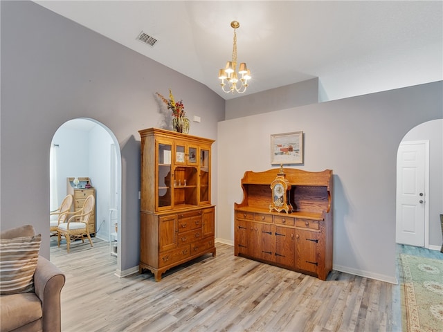 2540 12th Sq SW, Vero Beach, FL 32968 - interior space featuring arched walkways, light wood finished floors, a chandelier, and vaulted ceiling