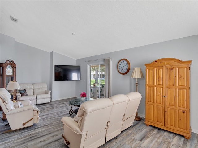 2540 12th Sq SW, Vero Beach, FL 32968 - living area with light wood-style flooring and lofted ceiling