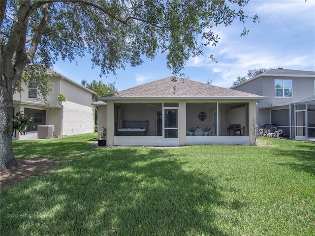 2540 12th Sq SW, Vero Beach, FL 32968 - back of property featuring a sunroom, a yard, a shingled roof, and stucco siding