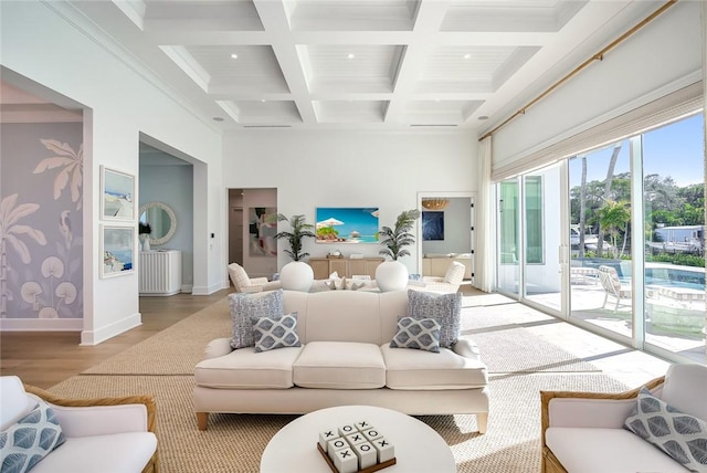 living room with hardwood / wood-style flooring, beam ceiling, ornamental molding, and coffered ceiling