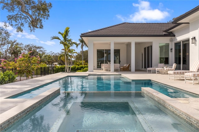 view of pool with a patio and an in ground hot tub