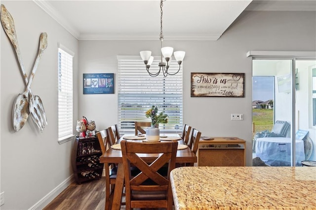 dining area featuring a chandelier, dark hardwood / wood-style floors, and ornamental molding