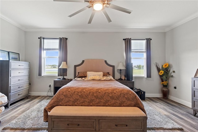 bedroom featuring ceiling fan, ornamental molding, and light hardwood / wood-style flooring