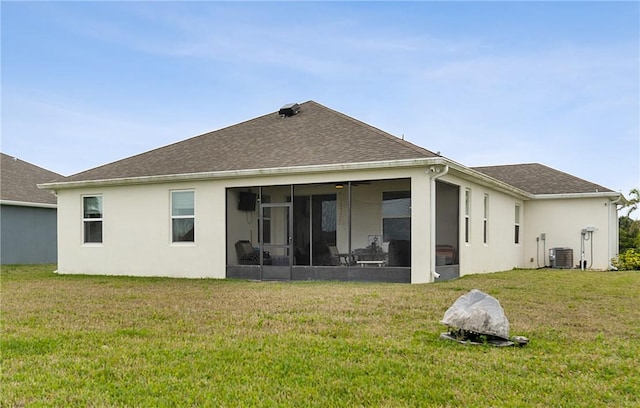 back of property featuring a lawn, a sunroom, and cooling unit