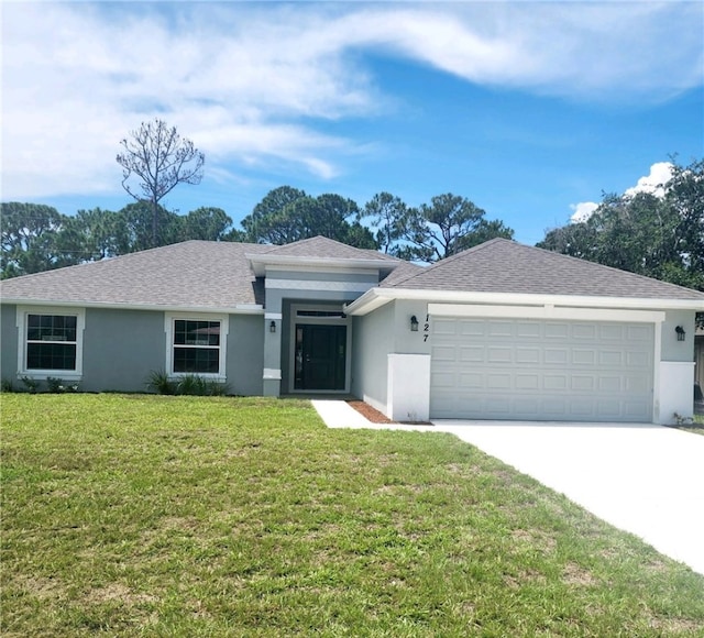 single story home featuring a garage and a front yard