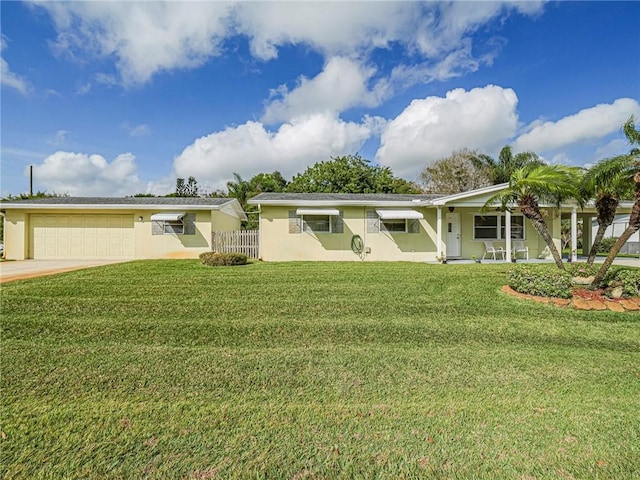 ranch-style home with fence, stucco siding, a front lawn, and a garage