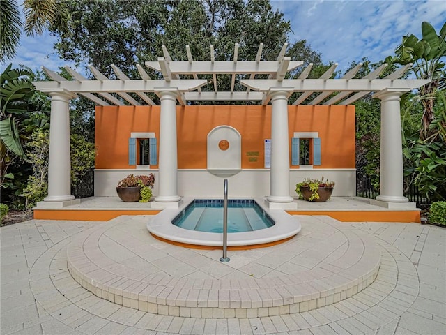 exterior space featuring a hot tub and a patio