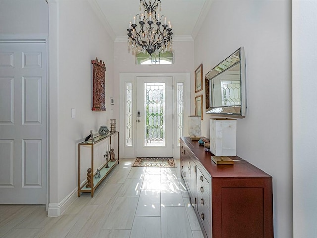 tiled foyer entrance featuring an inviting chandelier and ornamental molding