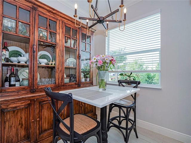 dining space featuring an inviting chandelier and crown molding