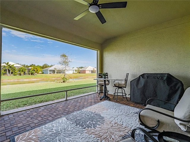 sunroom / solarium featuring ceiling fan