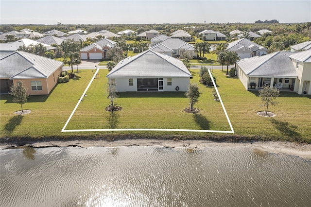 drone / aerial view with a water view and a residential view