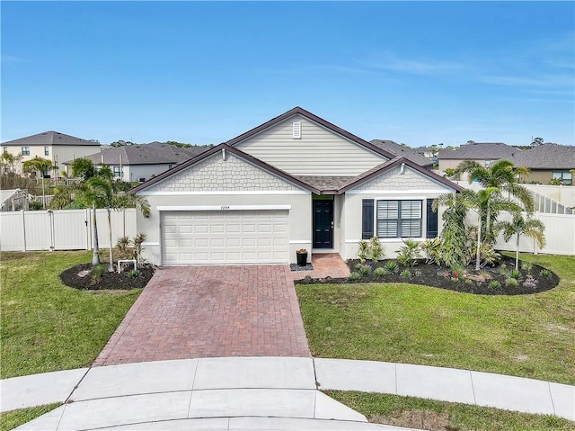 ranch-style house featuring a garage and a front lawn