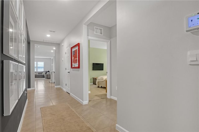 hall with light tile patterned floors